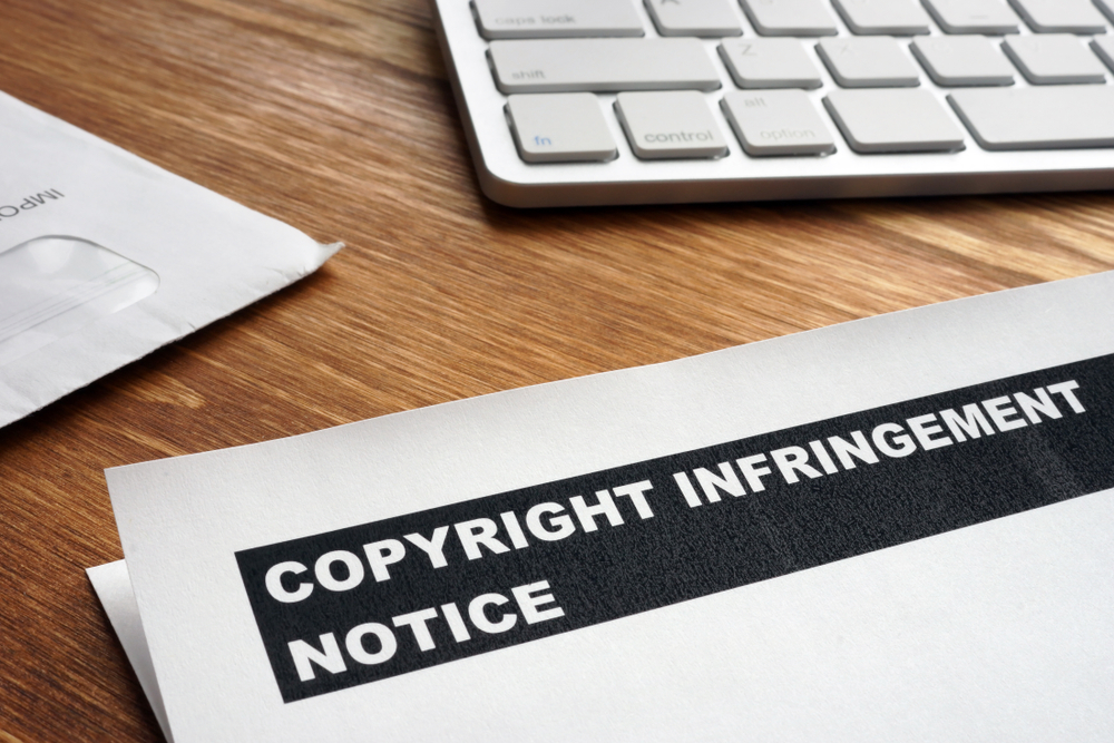 copyright infringement notice on desk with keyboard

